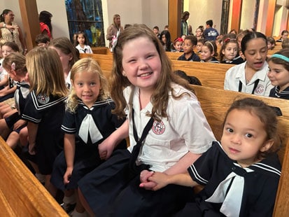 Older and younger SLES students sitting together in a pew