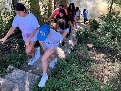 St Luke's Students hiking up stairs outdoors