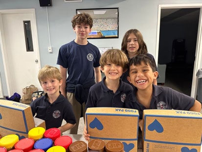 St. Luke's students helping pack donation boxes