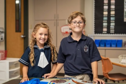 A girl and a boy elementary school students in school uniforms