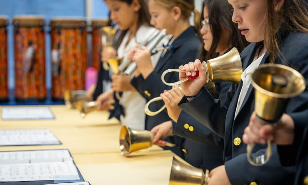 Students playing handbells in church