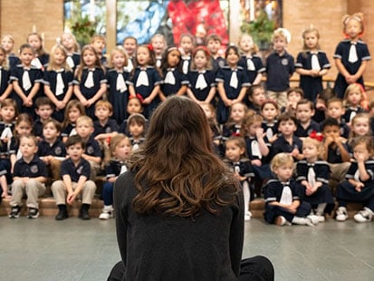 music teacher in chapel with students