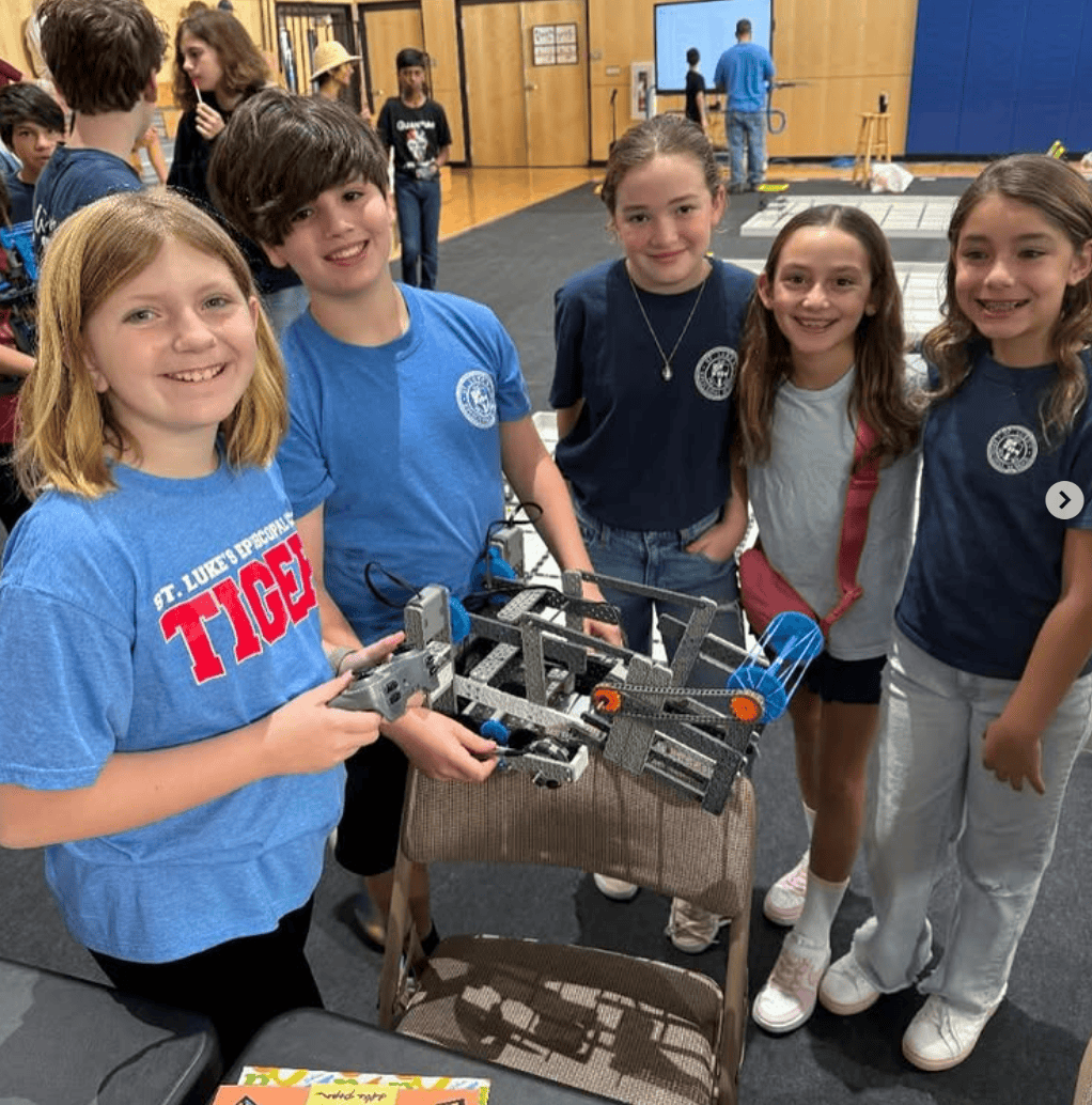 students with robots they built at school